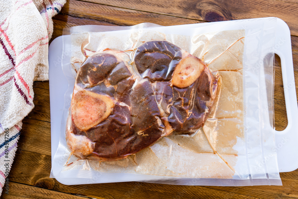 Wall mural two pieces of vacuum packed raw beef ossobuco ready for storage or sous vide cooking. animal protein