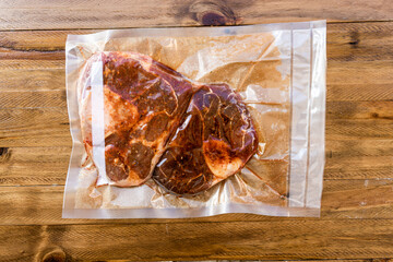 Two pieces of vacuum packed raw beef ossobuco ready for storage or sous vide cooking. Animal...