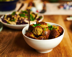 Selective focus shot of the delicious falafels with greenery on a plate