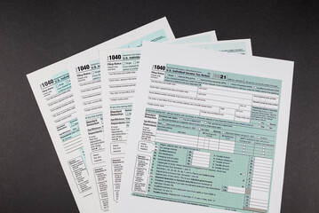 Tax forms 1040 on a black background.