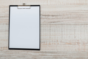 stationery tablet with blank paper on a wooden table. View from above. copy space