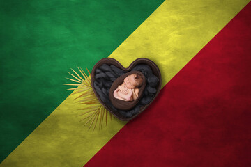 Newborn portrait in heart on background of national flag. Photography peace concept. Congo