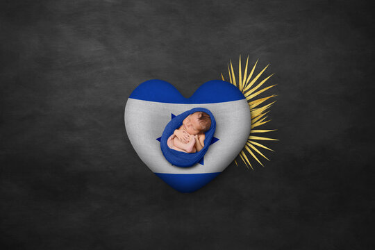Newborn portrait on heart in color of national flag. Photography peace concept. Israel