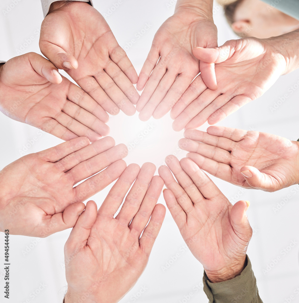 Poster we move as a unit. shot of a group of business people with their hands together in a circle.