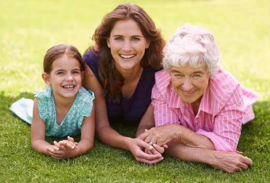 Three Generations Of A Loving Family. Shot Of A Generational Family Enjoying A Day Out In The Park.