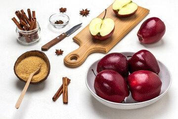 Ripe red apples in bowl. Brown sugar in coconut shell.