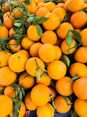 Close-up shot of a stack of fresh oranges a street market