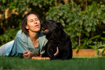 Wife Cuddling a teddy bear Labrador. Positive emotions showing the attachment between wife and pet love and trust and absolute endearment and enjoyment of the attention given