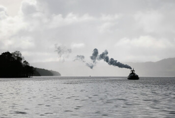 Steam yacht gondola sailing on Coniston Water with a smoke © Michael Metcalfe/Wirestock Creators