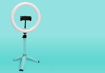 Selfie ring lamp with tripod, on a blue background
