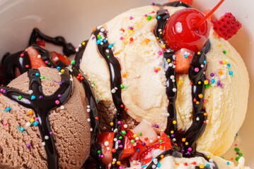 Chocolate and vanilla ice cream with various colorful and tasty toppings
