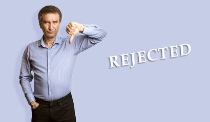 Frowning man showing negative feedback disapproval dislike sign.