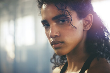Unfazed, unbothered, unshakeable. Closeup shot of a focused young sportswoman posing in the gym.