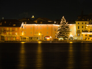 Beautiful winter day at Lake Garda, Italy with the Christmas lights reflecting on the water