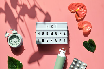 Text HRT Replacement Therapy on light box. Menopause, hormone therapy concept. Oestrogen...
