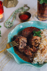 fork piercing meatball: Kibbe Summaqiyeh, kibbeh in sumac stock, meatball recipe from Aleppo