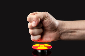 The hand presses the big red button. The concept of the threat of nuclear war. A threat to the...