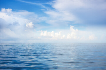 Sea scenery with blue calm water turning into a gradient in the horizon of the blue sky with the effect of infinity and tranquility
