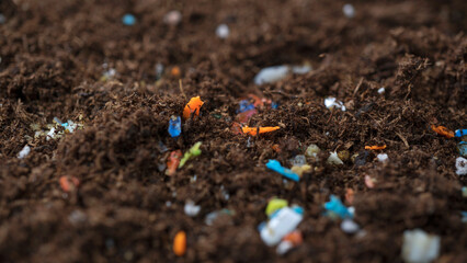 Microplastics inside the soil. Concept of global warming and climate change. Non-recyclable plastic...