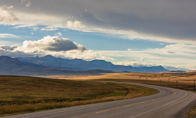 Highway through mountains landscape at overcast day. Horizontal shot