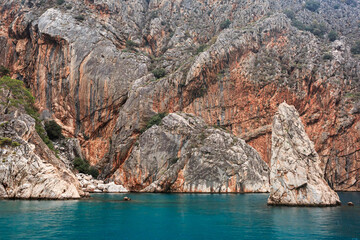 Fototapeta na wymiar Texture rocks, blue sea, ship board, beautiful landscape, mountains, cracks, colorful mountains.