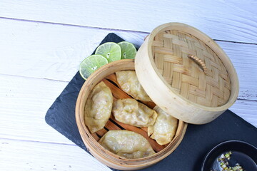 Steamed gyozas, oriental empanada, stuffed with meat, spices, onion, lemon and sauce