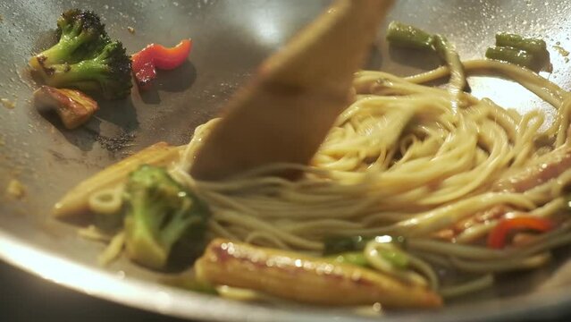 Cooking. Spaghetti With Vegetables. Cook Kneads Ingredients In Metal Dish On Fire.