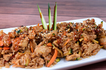 Sauteed wok rice, accompanied by beef tenderloin, vegetables, chicken, sesame, soy sauce and teriyaki