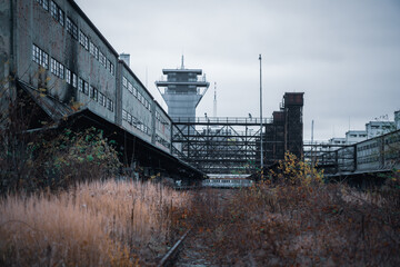 An old overgrown rail line leading into abandoned freight station in Prague