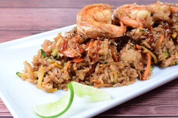 Sauteed wok rice, accompanied by beef tenderloin, vegetables, chicken, sesame, soy sauce and teriyaki