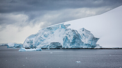 Die Abbruchkante einer Gletscherzunge in der Antarktis mit blau schimmernden Eis