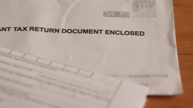 Envelope with tax return documents. Slider shot.
