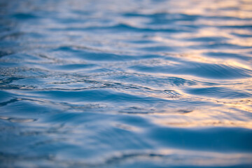 Closeup seascape surface of blue sea water with small ripple waves