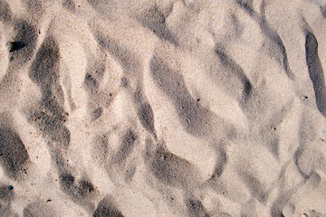 Flat view of clean yellow sand surface covering seaside beach. Sandy texture
