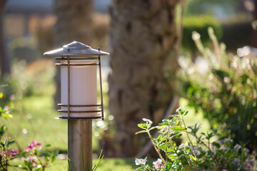 Outdoor lamp on yard lawn for garden lighting in summer park