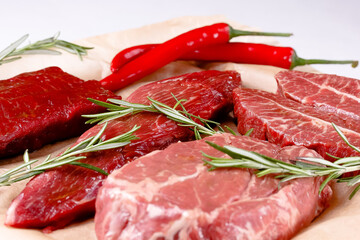 Rib Eye Steak, Striploin Steak, Butterfly Steak made of marble raw beef lie on the board