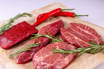 Rib Eye Steak, Striploin Steak, Butterfly Steak made of marble raw beef lie on the board