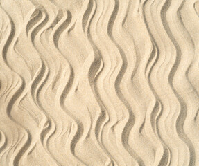 Fototapeta na wymiar Texture of sea sand background closeup with ornament