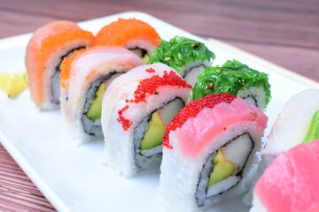 Traditional colorful suhi, cream cheese, salmon, caviar, rool sishi crunch, sesame seeds and sauce