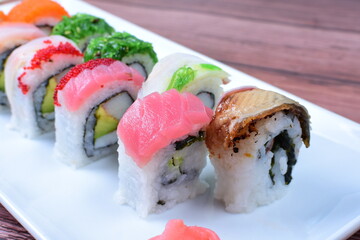 Traditional colorful suhi, cream cheese, salmon, caviar, rool sishi crunch, sesame seeds and sauce