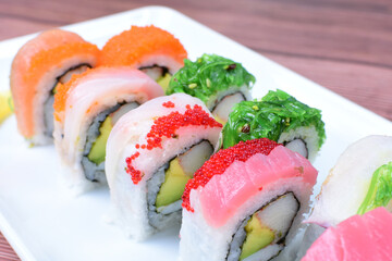 Traditional colorful suhi, cream cheese, salmon, caviar, rool sishi crunch, sesame seeds and sauce