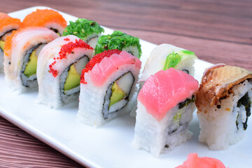 Traditional colorful suhi, cream cheese, salmon, caviar, rool sishi crunch, sesame seeds and sauce