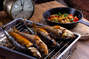 Smoked fish on the grill is on the table