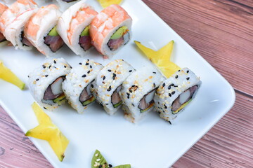 Traditional colorful suhi, cream cheese, salmon, caviar, rool sishi crunch, sesame seeds and sauce