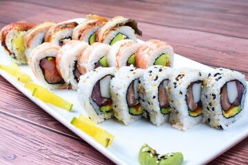 Traditional colorful suhi, cream cheese, salmon, caviar, rool sishi crunch, sesame seeds and sauce