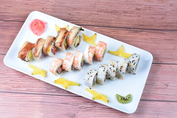 Traditional colorful suhi, cream cheese, salmon, caviar, rool sishi crunch, sesame seeds and sauce