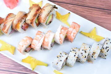 Traditional colorful suhi, cream cheese, salmon, caviar, rool sishi crunch, sesame seeds and sauce