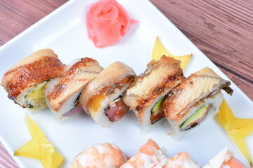 Traditional colorful suhi, cream cheese, salmon, caviar, rool sishi crunch, sesame seeds and sauce