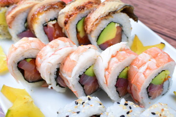 Traditional colorful suhi, cream cheese, salmon, caviar, rool sishi crunch, sesame seeds and sauce