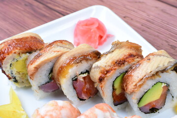 Traditional colorful suhi, cream cheese, salmon, caviar, rool sishi crunch, sesame seeds and sauce